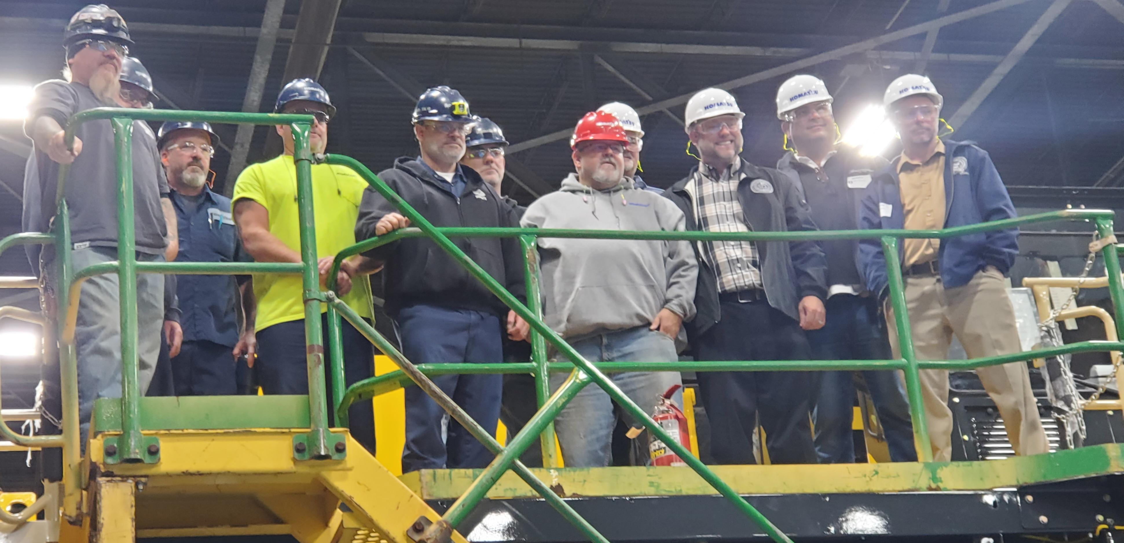 Union Members Stand on a Komatsu Truck